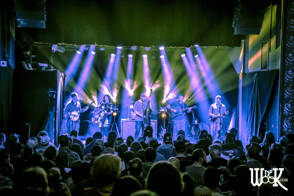 A crowd of people watching a band perform.